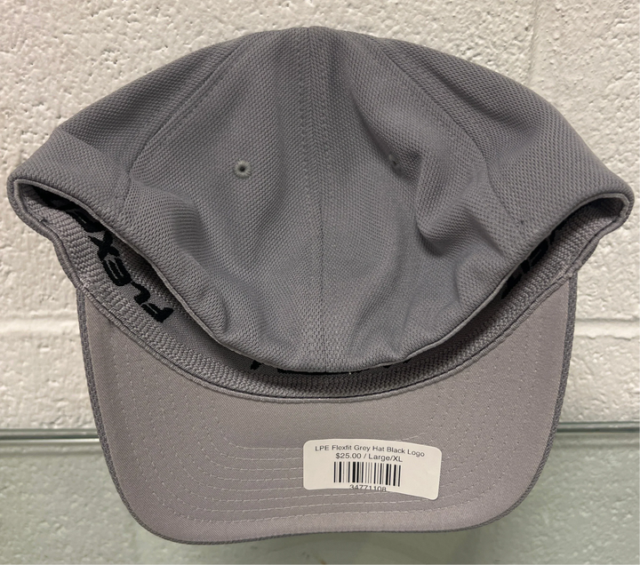 Gray cap with a brand label on a textured surface