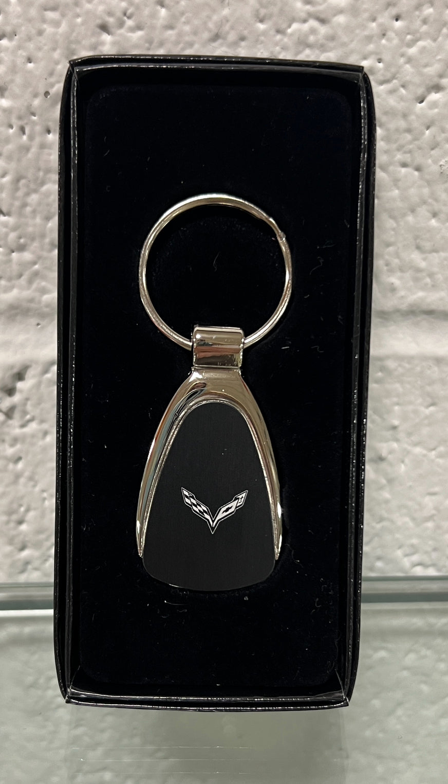Chrome teardrop keychain featuring a C8 Corvette design from Lingenfelter Race Gear, with detailed metallic finish and branding.