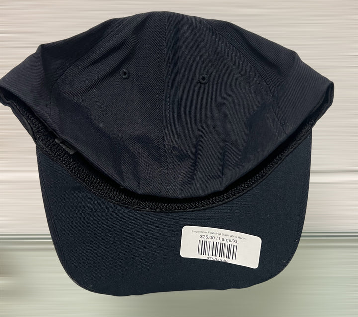 Black cap with a label on a neutral background