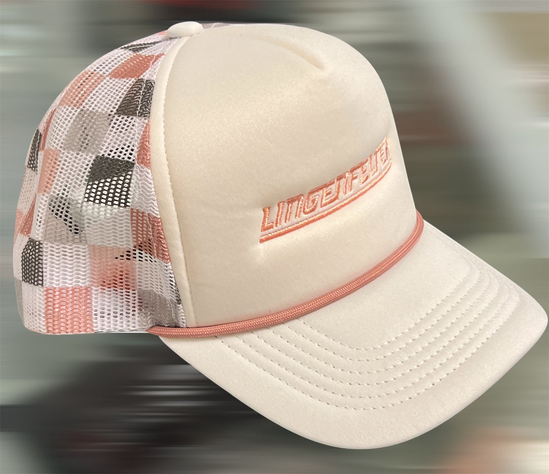 Beige cap with checkered mesh back and embroidered logo on a blurred background
