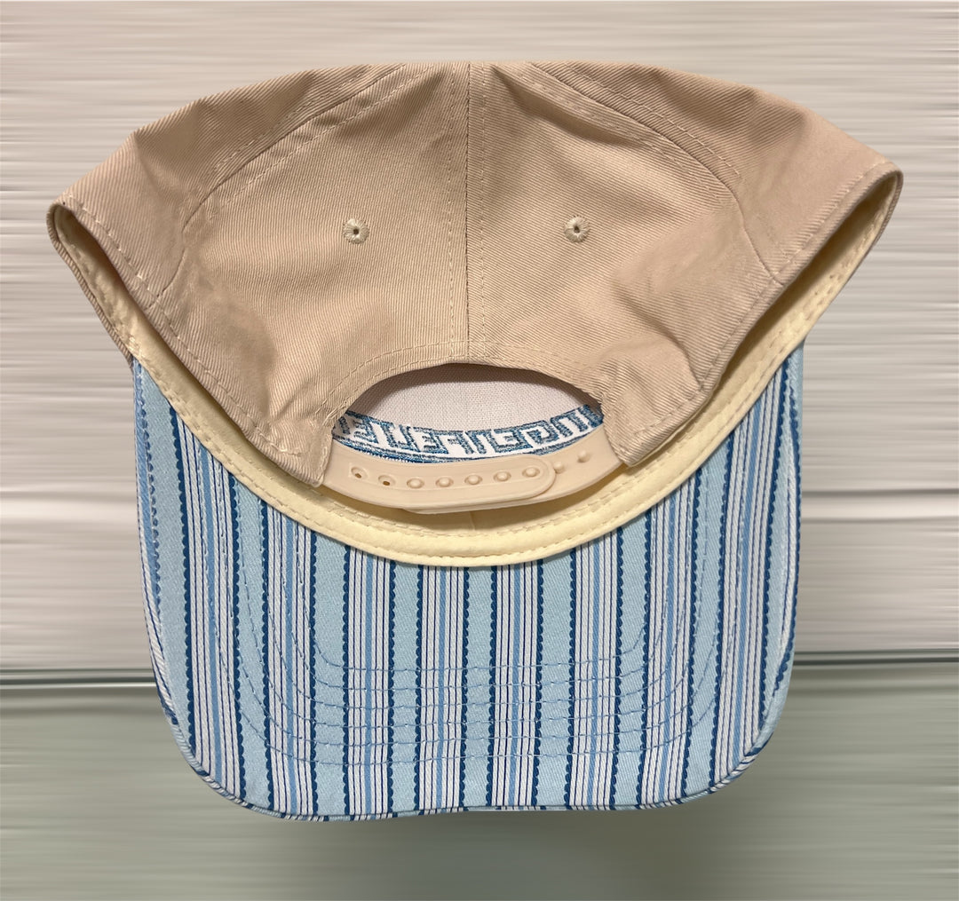Beige cap with blue striped interior on a neutral background