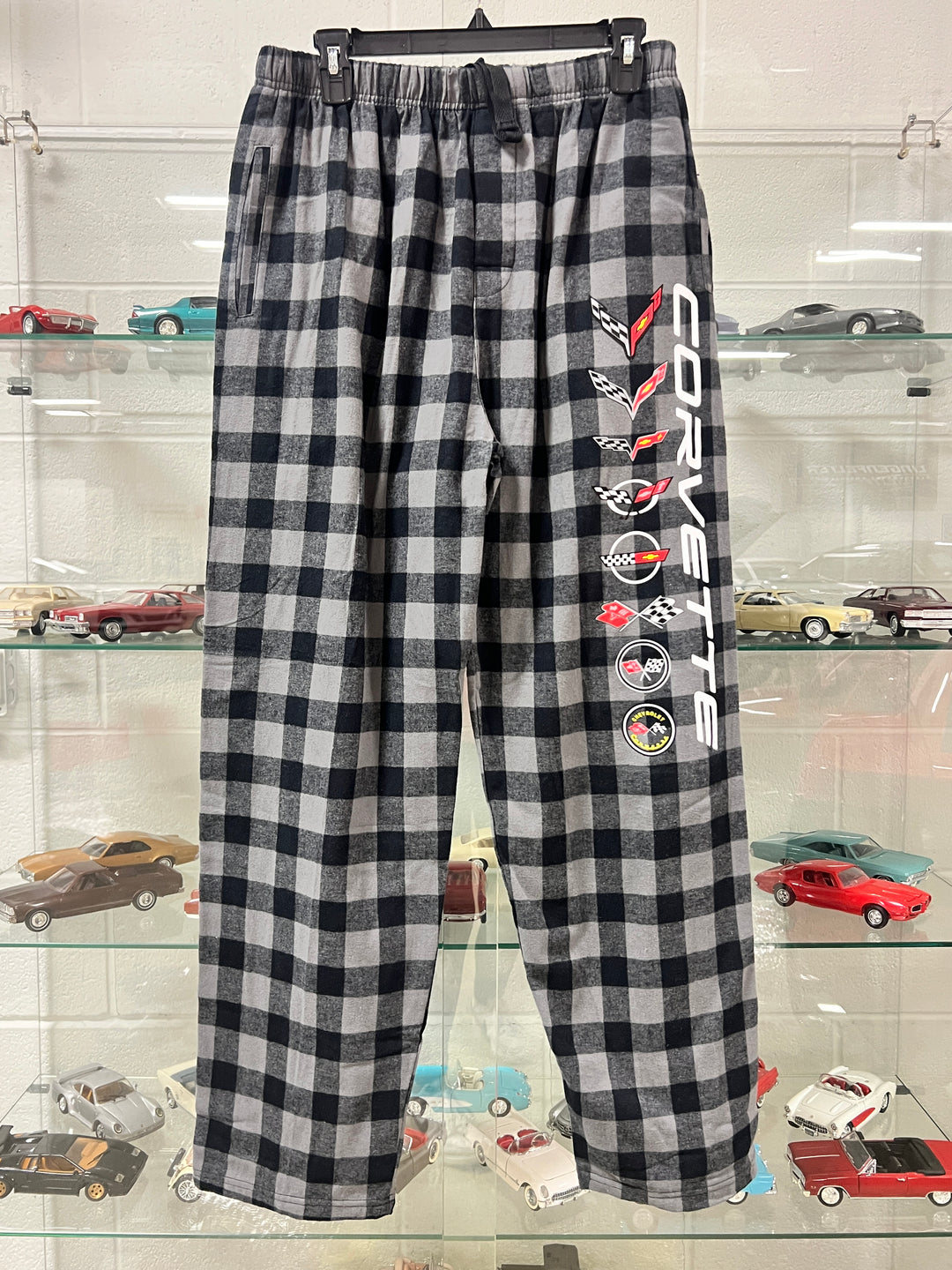 Black and white checkered fabric with Corvette logo and car graphics on a stand.