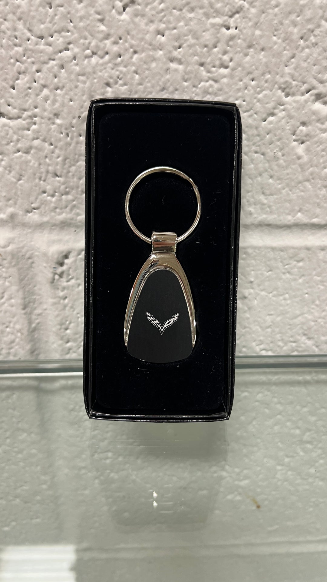 Chrome teardrop keychain featuring the C7 Corvette design, made by Lingenfelter Race Gear, with detailed Corvette logo and branding.