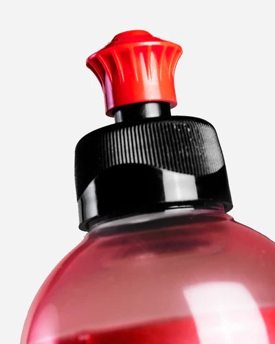 Close-up of a red bottle cap with black base on a white background