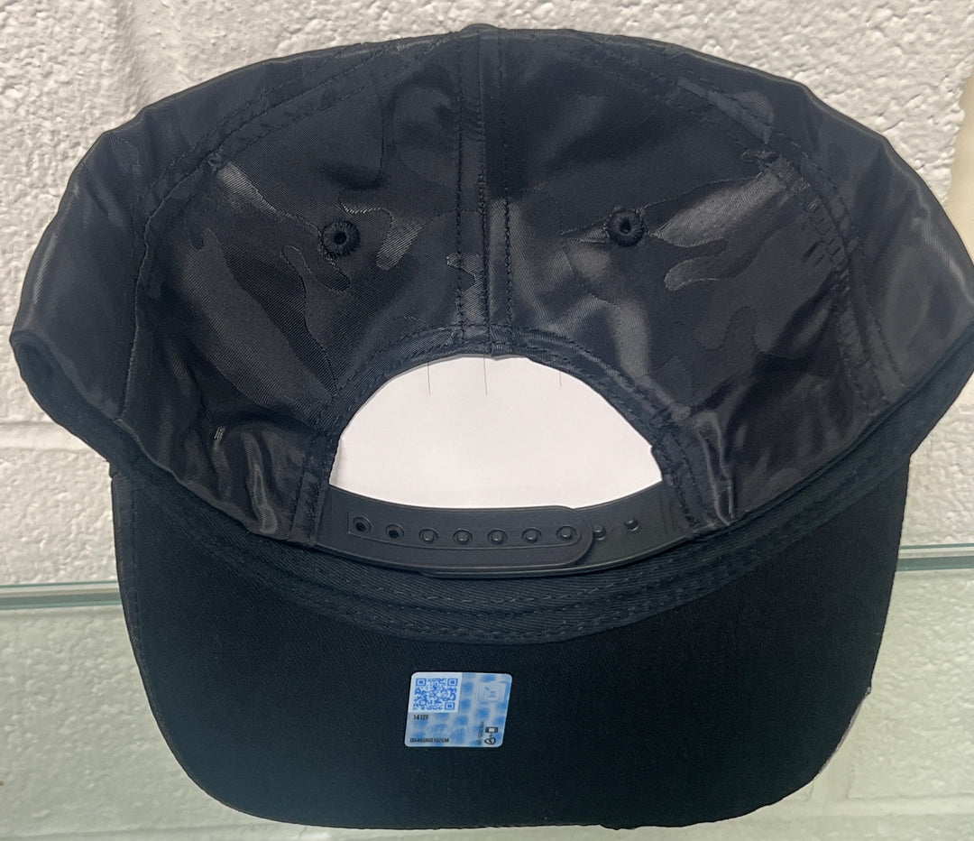 Back view of a black camo flag hat by Lingenfelter Race Gear, featuring a structured design and adjustable strap.
